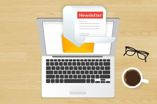 A laptop displaying a chamber of commerce newsletter emerging from an envelope symbolizing an email application.