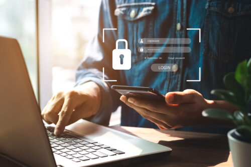 cyber security image of someone logging into their computer with a secure password graphic